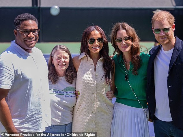 Alex Romain (left), chair of the Alliance for Children's Rights, joins Meghan (centre), Kelly McKee Zajfen (second right) and Prince Harry (far right) at the tennis tournament in September