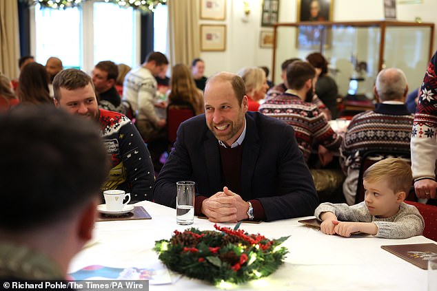 The future king opted for a navy suit with a light blue open collar shirt and jumper. He added brown suede shoes, a classic smart casual look for the Princ