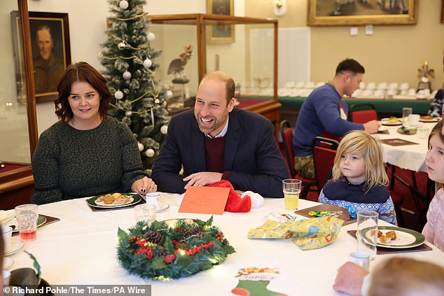 Prince William spread festive cheer today as he gave out presents to children of soldiers at Picton Barracks