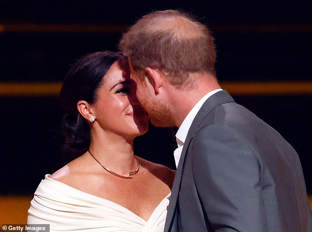 The couple gaze into each other's eyes and smile on stage during the opening ceremony of the Invictus Games in 2020