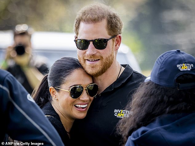 Meghan beams as she leans into her husband at the Invictus Games in 2022