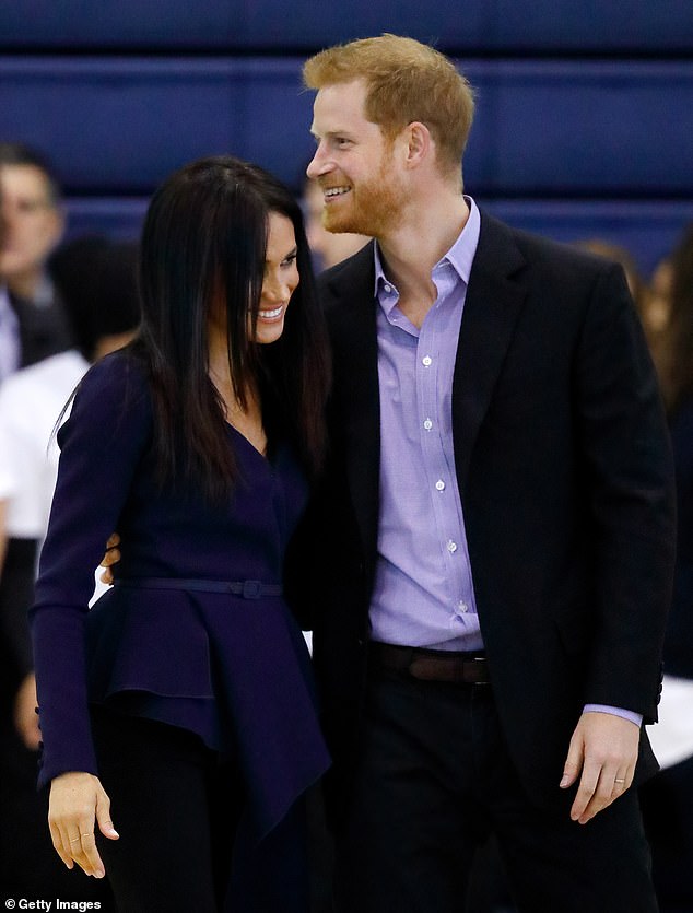 Harry lovingly places his arm around his wife's waist and they both smile while they attend the Coach Core Awards held at Loughborough University in September 2018