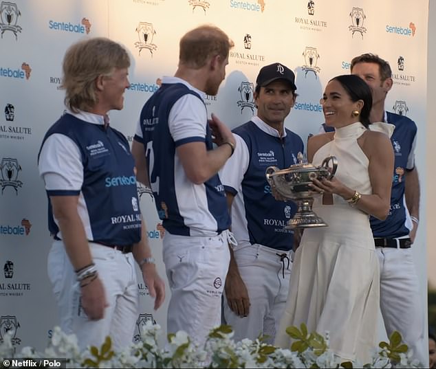 They seemed to share an inside joke as Meghan presented the winner's trophy to her husband, Ms James noted