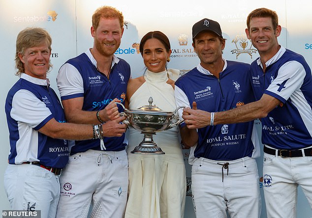 Meghan took centre stage as the team gathered around to celebrate their win