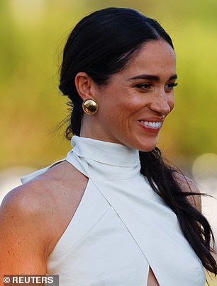 Meghan had her hair pulled back in a low ponytail