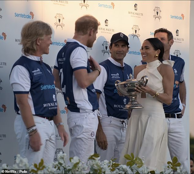 After the match, which Harry and his teammates went on to win, the Duchess was seen presenting her husband with a trophy