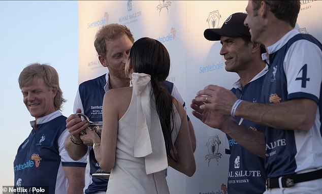 The Duke of Sussex was beaming ear-to-ear as the pair puckered up for a kiss in front of waiting photographers and the Netflix camera crew.