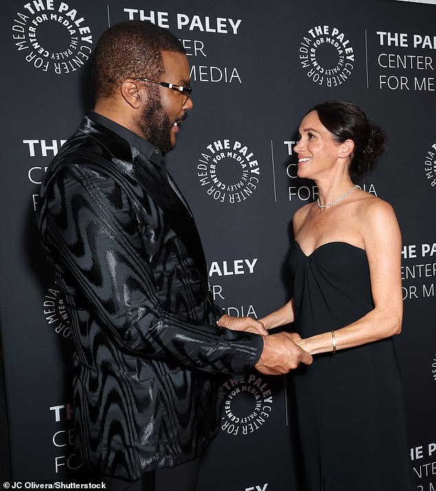 Meghan held hands with Perry as they greeted each other in front of the shutterbugs