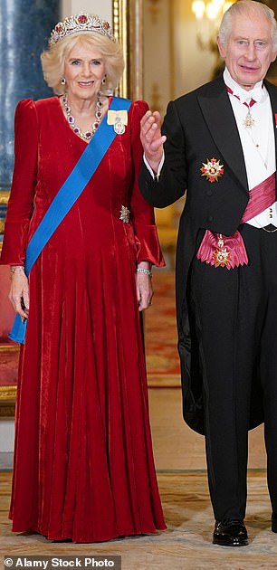 The Queen looked a picture of elegance in a a maroon Fiona Clare gown for a State Banquet