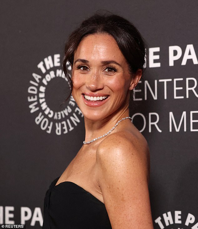 The Duchess of Sussex, 43, put on a very animated display as she took in a woman's hand at marvelled at her ornate jewellery at the The Paley Center, where she was on hand to support her friend Tyler Perry at The Paley Honors gala in Beverley Hills