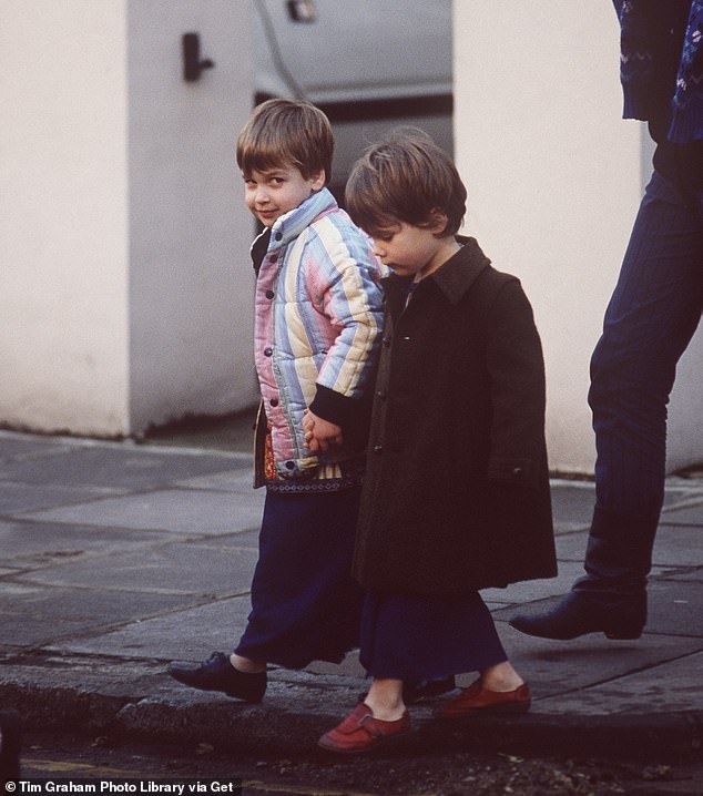 William holding a classmate's hand and dressed in costume for his nativity play in 1986