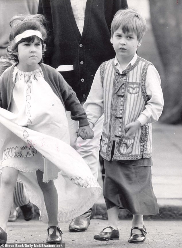 Prince William, holding a school friend's hand, dressed in cotton shirt and and striped jacket ready for his role as inn keeper in 1986