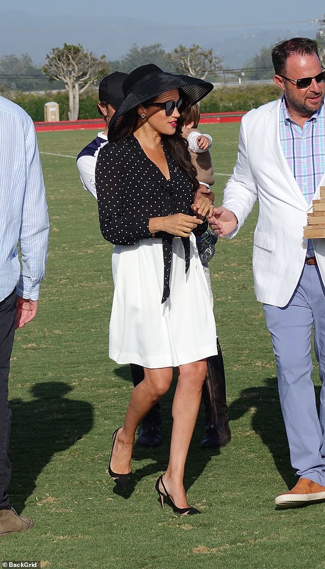 Meghan sported a chic Celine polka dot tie-neck blouse, Khaite shorts and Aquazzura heels for a polo match in 2022