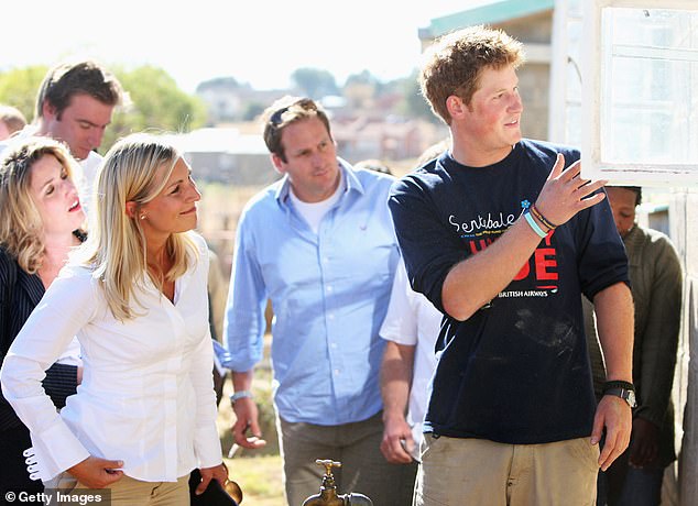 Harry explaining the school-building project to journalists, including the Mail's Rebecca English (far left), in Lesotho in 2008