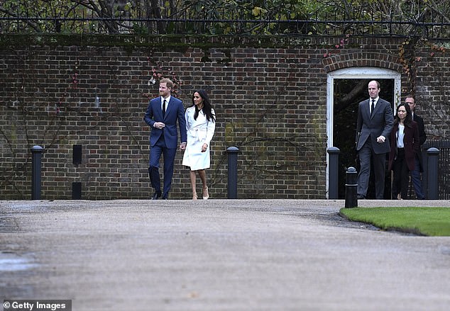 Prince Harry and Meghan Markle walk to the photo call at Kensington Palace