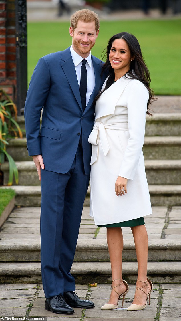 Prince Harry and Meghan Markle pose in the Sunken Garden at Kensington Palace for their official engagement photo call, which came immediately before the interview