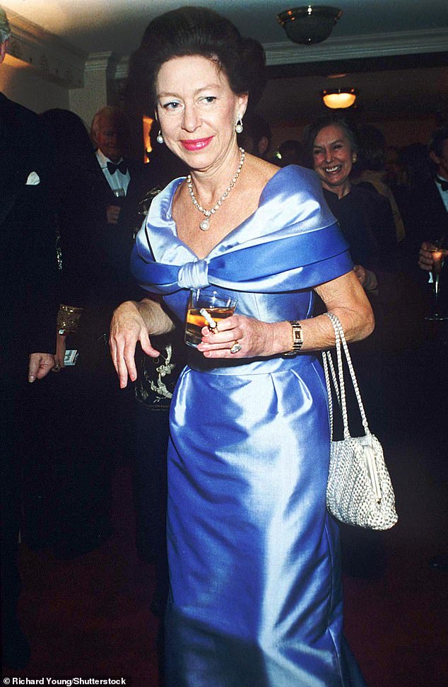 The late princess holding a drink and cigarette at a theatre in London in 1991