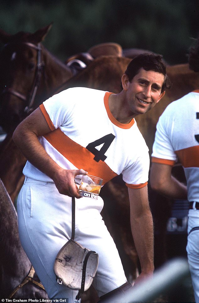 The former Prince of Wales carries a glass after competing in a polo match in Windsor in 1979