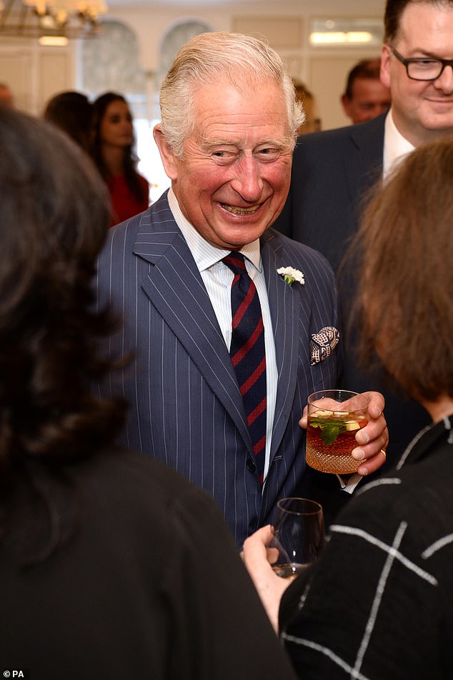 Charles smiling as he holds a drink at the Fortnum & Mason Food and Drink Awards in 2019