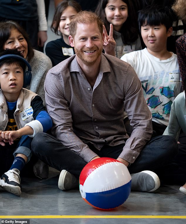 Prince Harry, the Duke of Sussex, poses for a photo with elementary school students during the Invictus Games 2025 School Program Launch Event at Seaforth Armoury on November 18, 2024