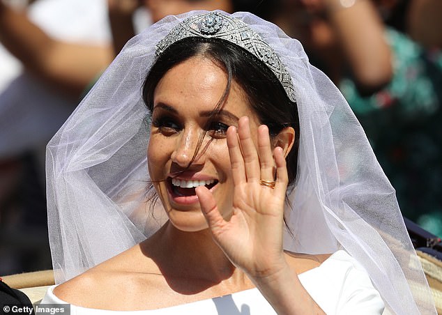 Meghan waving with the tiara on her head at her wedding in St George's Chapel at Windsor Castle on May 19, 2018