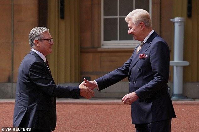 Sir Clive Alderton greets Sir Keir Starmer as he arrives at Buckingham Palace for an audience with King Charles III where he was invited to become Prime Minister following the landslide General Election victory for the Labour Party on July 5, 2024