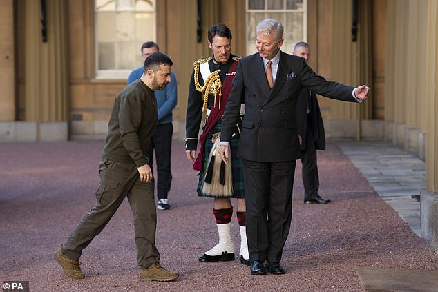 Sir Clive welcomes in the war leader as he arrives for an audience with the King at Buckingham Palace