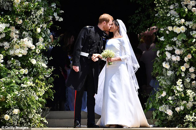 The Duke of Sussex kissing his wife as they leave St George's Chapel, Windsor, on their wedding day in May 2018