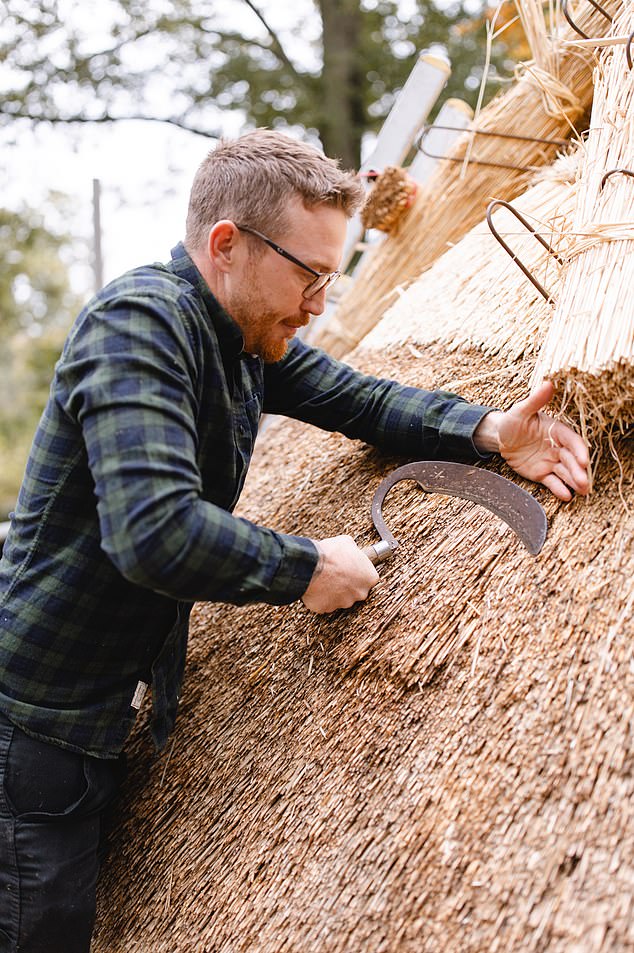 It has been re-thatched by Ben Collyns, 36, (pictured) appropriately an alumnus of The King¿s Foundation Building Craft Programme at Dumfries House in Scotland