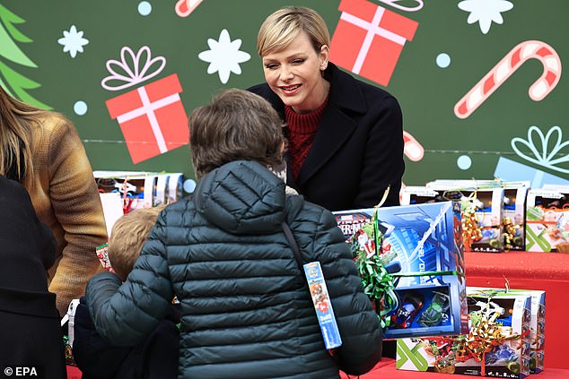 Charlene chats to families who were visiting the palace for the gift giving event last year