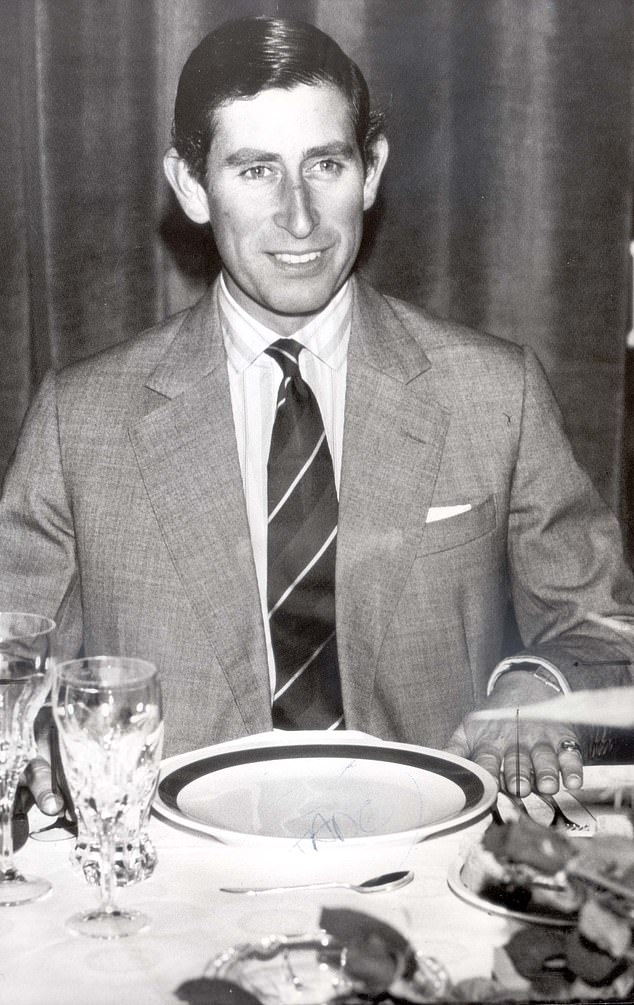 Prince Charles sitting at a dinner table after attending a Christmas service in 1982