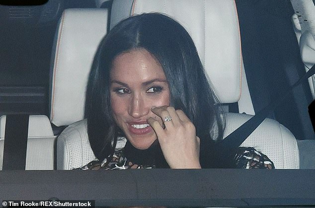 Meghan beamed as she was photographed in the car leaving the family lunch