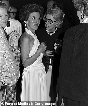 A glamorous Nancy Reagan opted for his white halter neck dress in 1973