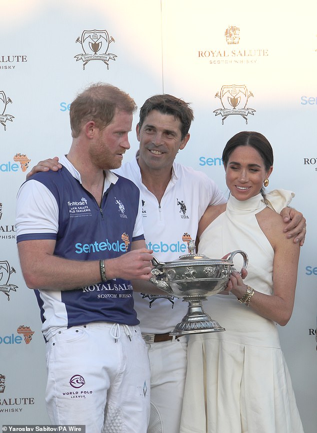 Meghan presents her husband with a trophy at a polo game in April