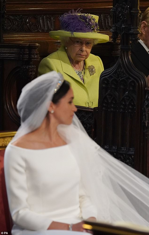 Meghan at her wedding to Prince Harry with Queen Elizabeth II looking uneasy in the pews. Nearly 28million people in Britain watched the royal wedding on TV