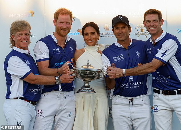 Pictured: Prince Harry and Meghan, Duchess of Sussex, pose with other players as they attend the Royal Salute Polo Challenge to benefit Sentebale