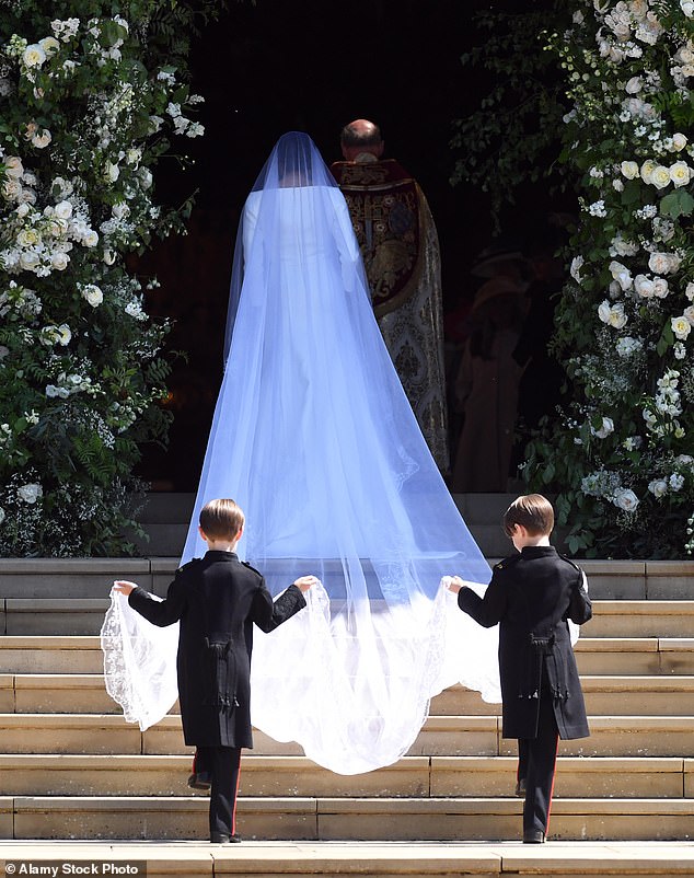 Two page boys were required to help carry the £100,000 dress's long veil into the chapel