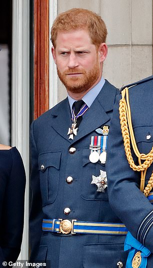 Prince Harry pictured in 2018 wearing full military dress with the Duchess of Sussex and Prince William at Buckingham Palace