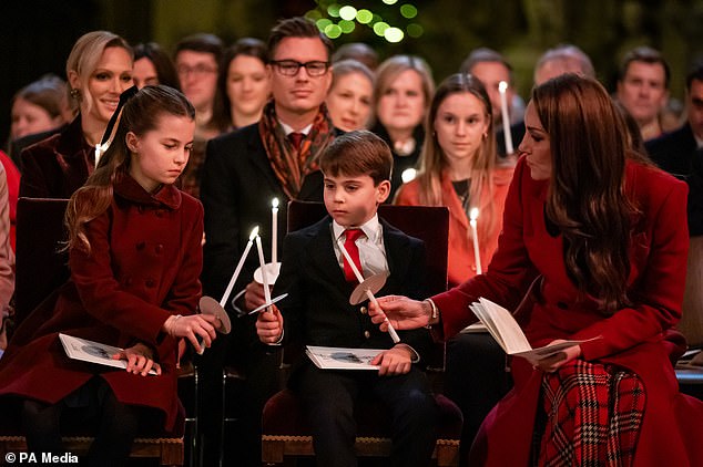 Princess Charlotte, Prince Louis and the Princess of Wales hold candles as they take a pew in Westminster Abbey during the service