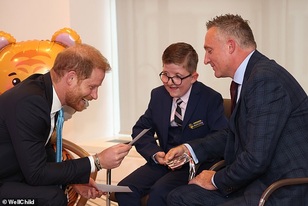 In contrast, Harry's journey to London for the WellChild awards for ill children in September was widely praised. Pictured speaking to Lewis Connett, aged 11