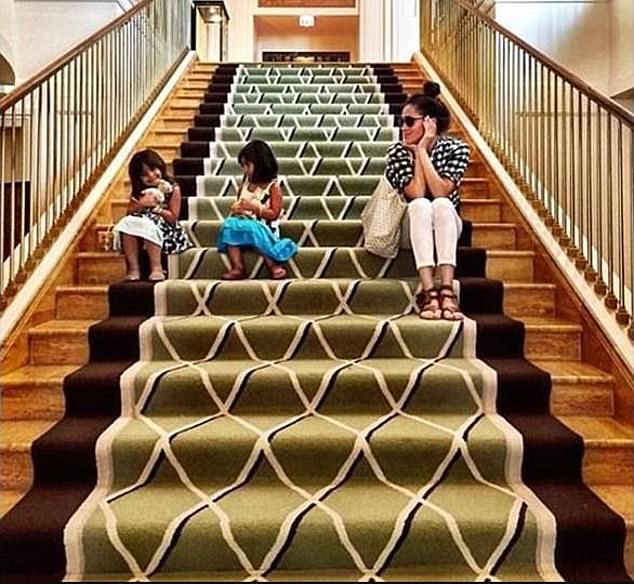 In one picture, she is seen gazing two children playing on a grand staircase, describing the youngsters as her 'fairy goddaughters'