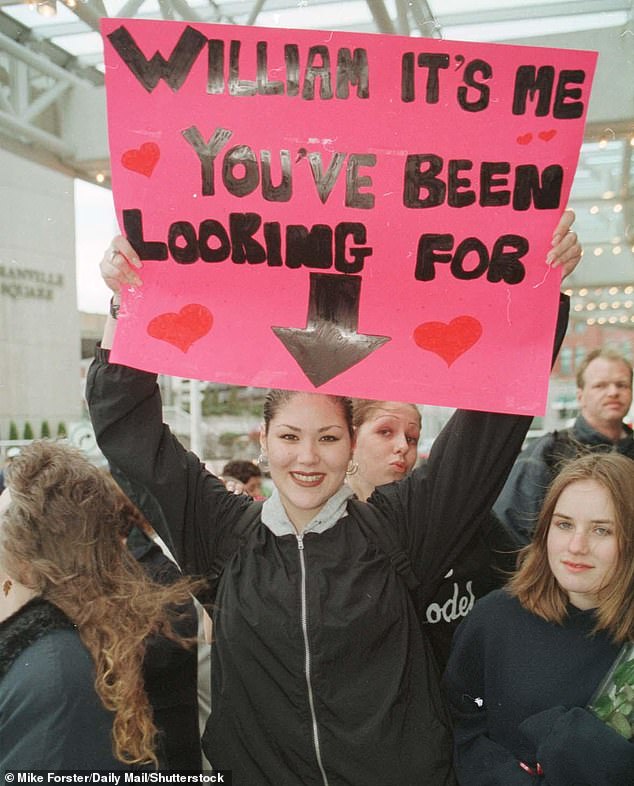 A royal fan holding up a sign for Prince William in Canada during the Royal Tour in 1998