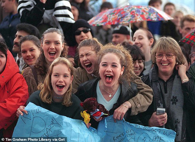 Crowds of young girls cheering and holding signs for the prince in Vancouver