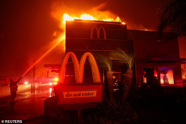 Firefighters work to extinguish flames at a McDonald's in Pasadena on January 7