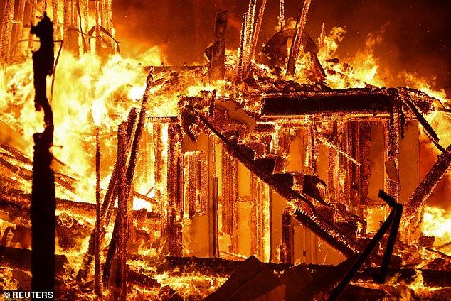 Flames engulf a structure as the Eaton Fire burns in Pasadena on January 7