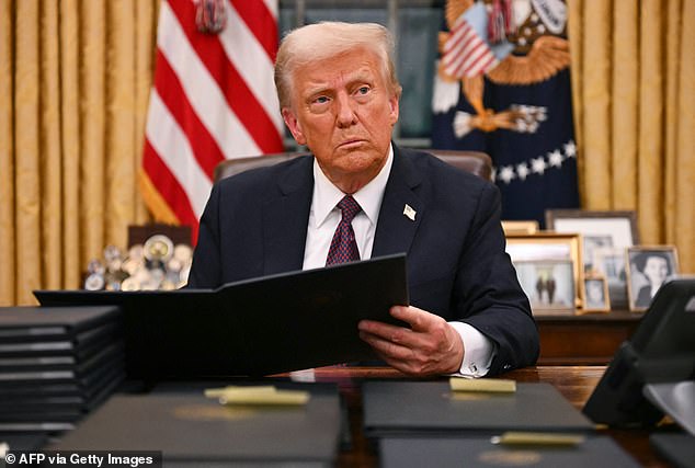 US President Donald Trump pictured in the Oval Office on January 6 signing an executive order for pardons. He has previously said he 'wouldn't protect' Harry