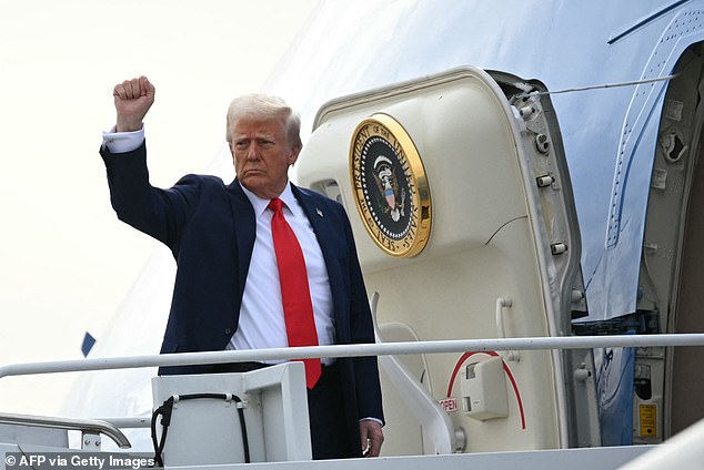 Trump gestures as he boards Air Force One upon departure from Harry Reid International Airport in Las Vegas, Nevada -- January 25, 2025