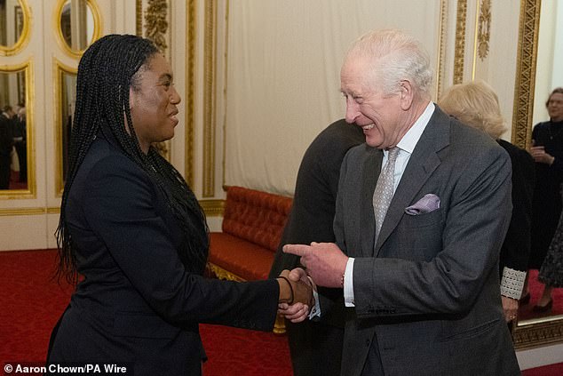 King Charles shakes hands with Kemi Badenoch during a reception for members of Parliament newly elected in the 2024 election