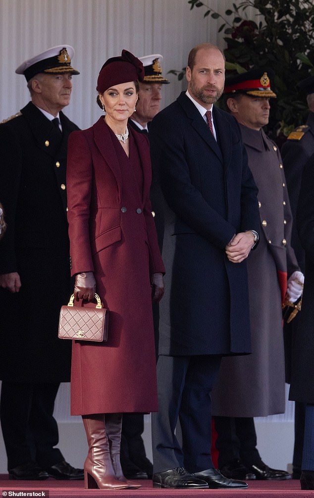 Kate greeted the Emir of Qatar during his state visit to the UK in a flawless burgundy ensemble