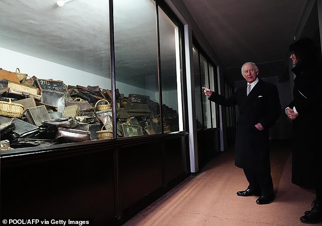 King Charles III looked at suitcases during a tour at the Memorial and Museum Auschwitz-Birkenau